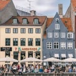 Especially during summer Nyhavn is the perfect place to end a long day. Have dinner at one of the cosy restaurants or do like the locals and buy a beer from a nearby store and rest your feet at the quayside.

Nyhavn was originally a busy commercial port where ships from all over the world would dock. The area was packed with sailors, ladies of pleasure, pubs and alehouses.

Today the beautiful old houses have been renovated and classy restaurants dominate the old port. Nyhavn is filled with people enjoying the relaxed atmosphere by the canal, jazz music and great food. 

No. 9, Nyhavn, is the oldest house in the area dating back to 1681. The design of the house has not been altered since that time.
Many of the houses lining the quays of Nyhavn have been the homes of prominent artists.