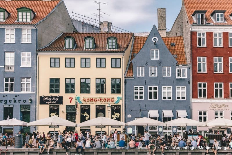 Especially during summer Nyhavn is the perfect place to end a long day. Have dinner at one of the cosy restaurants or do like the locals and buy a beer from a nearby store and rest your feet at the quayside.

Nyhavn was originally a busy commercial port where ships from all over the world would dock. The area was packed with sailors, ladies of pleasure, pubs and alehouses.

Today the beautiful old houses have been renovated and classy restaurants dominate the old port. Nyhavn is filled with people enjoying the relaxed atmosphere by the canal, jazz music and great food. 

No. 9, Nyhavn, is the oldest house in the area dating back to 1681. The design of the house has not been altered since that time.
Many of the houses lining the quays of Nyhavn have been the homes of prominent artists.